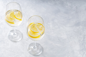 Hugo Spritz Cocktail in Glass with Lemon on Gray Background, Summer Alcoholic Drink