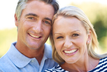 Mature, couple and smiling portrait in park, nature and weekend break in summer with love. Romance, trust and support for bonding together or outside, smile and people in married relationship