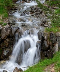 Serene waterfall flowing over rocks in a lush green forest