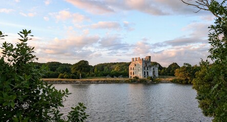 Fototapeta premium Beautiful scenery of Menlo Castle 16th century ruin by the River Corrib at sunset in Galway, Ireland, historic architecture