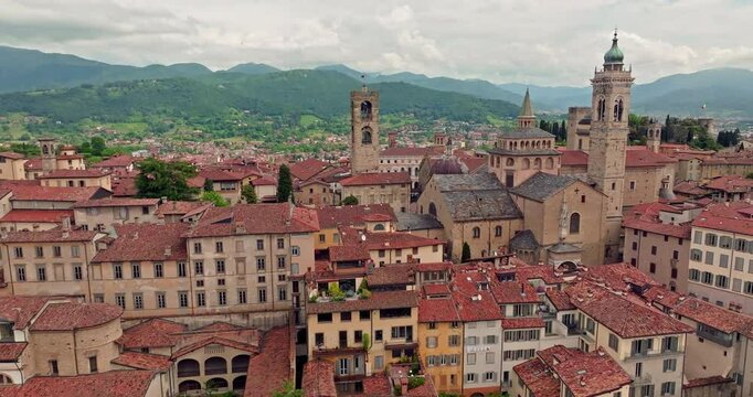 Aerial view of the cityscape of the cathedral in Bergamo, Italy. The architecture of the central square of the tourist historical center in the landscape of the mountains. High quality 4k footage