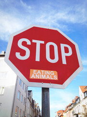 Obraz premium Stop sign with sticker slogan to stop eating animals