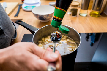 Chef at the kitchen preparing healthy quinoa bowl with avocado