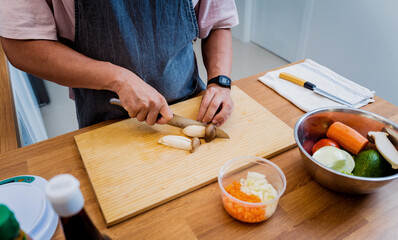 Chef at the kitchen preparing healthy quinoa bowl with avocado