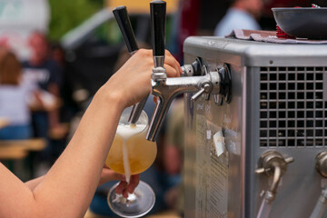 People cheer the party with craft beer in a sommelier glass with bokeh background