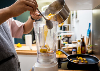 Chef at the kitchen preparing pumpkin porridge with tofu and vegetables