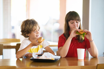 Kids eating fastfood. Unhealthy junk food.