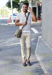 Black man, headphones and student for street commute, walking and listening to music in city. Male person, hearing audio and streaming sound on journey to college, travel and podcast in urban town