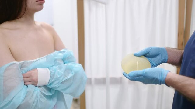 A young woman at a mammologist's appointment. Consultation on breast shape correction - lifting, reduction, reconstruction, enlargement, implants. Breast cancer awareness. Cosmetic Plastic Surgery
