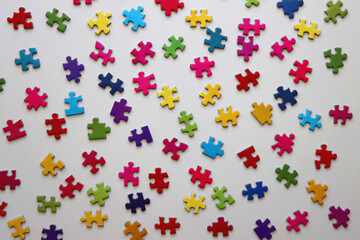 Colorful jigsaw puzzle pieces on white background. Flat lay.