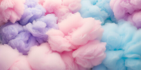Obraz premium Close-up of fluffy cotton candy in pastel pink, blue, and purple hues. Sweet themed designs, childhood nostalgia concepts, or dreamy, whimsical backgrounds.