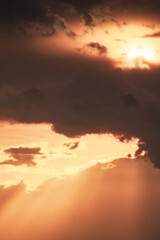 rays of beautiful sun through the clouds and thick fog on the eve of a thunderstorm front and lightning on the horizon