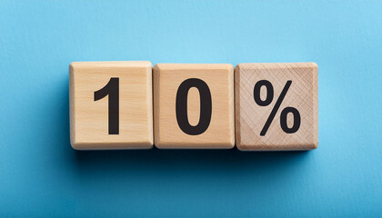 Wooden cubes with text 10% on isolated blue backdrop. Wood blocks, ten percent. Close-up. Flat lay