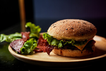 Burger served on a wooden plate with lettuce, onion, tomato, big patty, bacon, social media post, food photography, fine dining, restaurant menu, fast food, junk food, street food, delicious