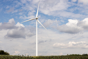 Fototapeta premium Windmill on field with clouds on sky on background, Czechia