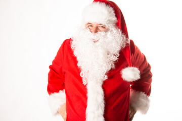 A man dressed as Santa Claus poses in the studio.