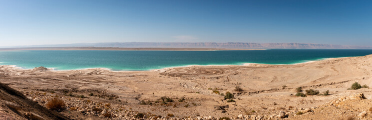 Panoramic view of Dead Sea seen from Jordan looking towards Westbank against blue sky