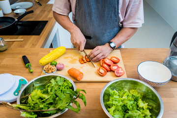 Chef at the kitchen preparing spicy glass noodle salad