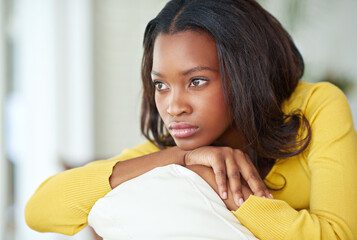 Black woman, depressed and thinking on home sofa with mental health, anxiety and divorce...