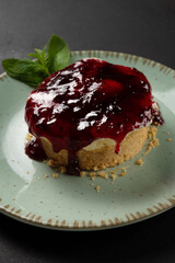 Home made mini Cheesecake on plate on dark background.