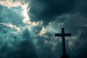Fototapeta premium Christian cross silhouetted against a dramatic sky with rays of sunlight breaking through the clouds, symbolizing hope and faith 