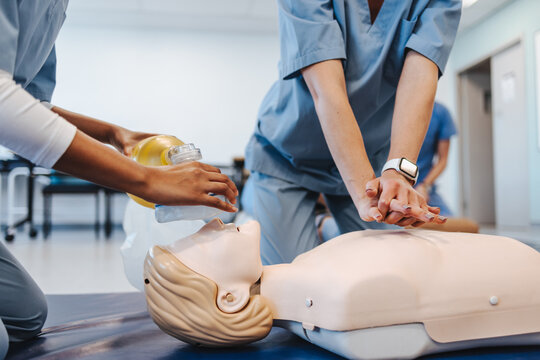 Students practice CPR on manikin during healthcare simulation in medical school