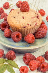 Fresh baked muffin with raspberries and chocolate. Delicious dessert for different occasion