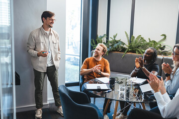 Collaboration and success: Business team applauding a colleague for his contribution to the company