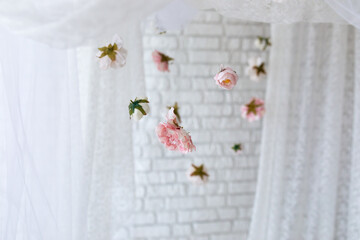 Summer pink peonies flowers levitating, hanging flowers on a white background, copy space. Template, mockup. White lace texture curtains with floral abstract pattern with spring flowers levitate	
