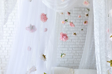 Summer pink flowers levitating, hanging flowers on a white background, copy space. Template, mockup. White elegance lace texture curtains with floral abstract pattern with spring flowers levitate	
