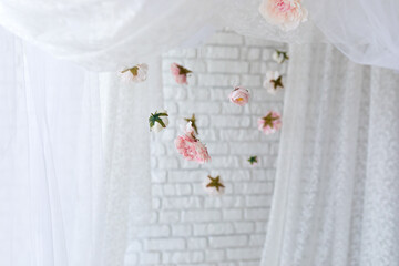 Baldachin on bed. Summer pink peonies and roses flowers levitating, hanging flowers, copy space. Template, mockup. White lace curtains canopy with floral abstract pattern with spring flowers levitate  © stock_studio
