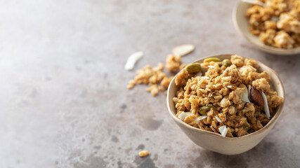 Crispy homemade granola with sliced almonds in a bowl. Healthy food. Copy space