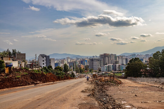 Wide city skyline beneath a cloudy sky