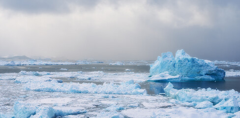 Iceberg, seascape or nature in Arctic for wallpaper, ocean or storm brewing in Greenland. Global...