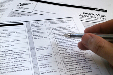 Man filling a New Zealander visa application form