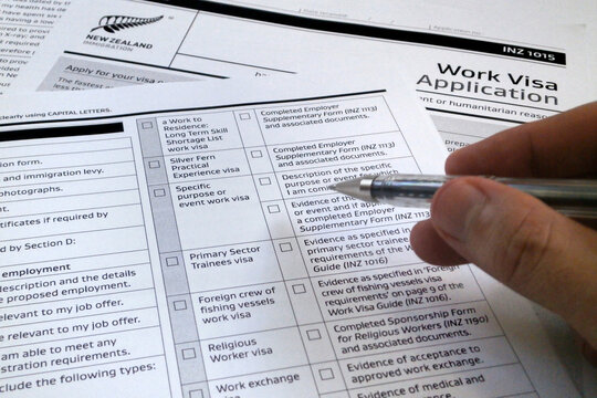 Man filling a New Zealander visa application form
