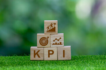 OKR Objectives, Key and Results wooden blocks on green nature background business goals and drive...