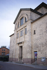 Obraz premium Historic Stone Building with Large Windows and Weathered Facade 