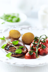 Grilled pork steak with vegetables. White wooden background. Close up. Copy space.	