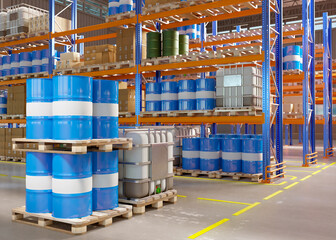 Large warehouse. Storage area. Industrial warehouse plant. Metal and plastic barrels are stored at storehouse. Fuel tanks on pallets. Spacious warehouse. Storehouse building without anyone. 3d image