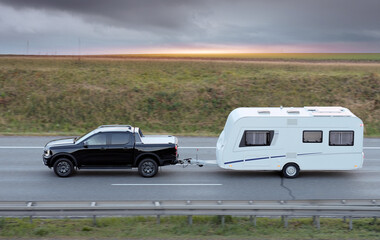 Family Vacation Trip On Black Pickup Truck With White Camper Trailer