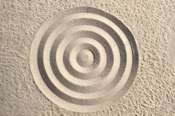 Naklejka premium A circle in the sand. Zen Japanese garden. Background.