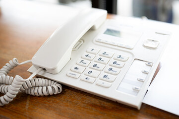 Close up of telephone devices on desk for customer service support. Call center concept.