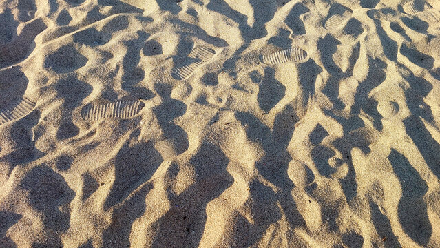 sand beach texture background with foot steps