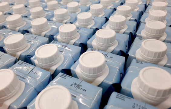 Easy to open screw caps on rows of milk cartoon. Milk cartoon packaging on rows