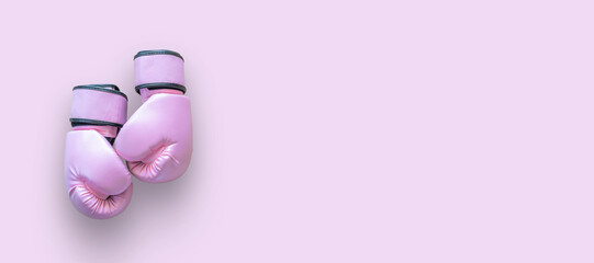 Breast cancer awareness month concept with pink boxing gloves isolated (clipping path) for girl and woman fight with illness on pink background with copy space