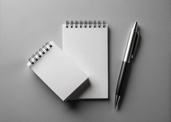 Minimalist logo design on a crisp, white notepad, paired with a sleek pen and modern business card, against a bright, seamless background.
