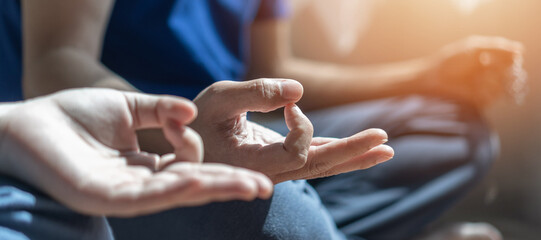 Human spirit meditation therapy, metal balance concept with yogi person hands in yoga lotus pose having spiritual meditating, relaxing in peace silencely in gym class or home indoor in the morning