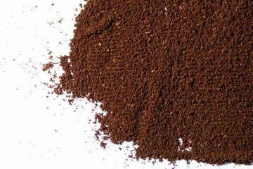 Scattered ground natural coffee on white background