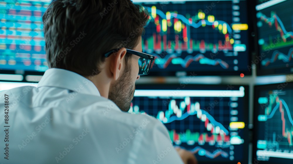 Poster stock trader looking at stocks and shares on computer in a high rise office